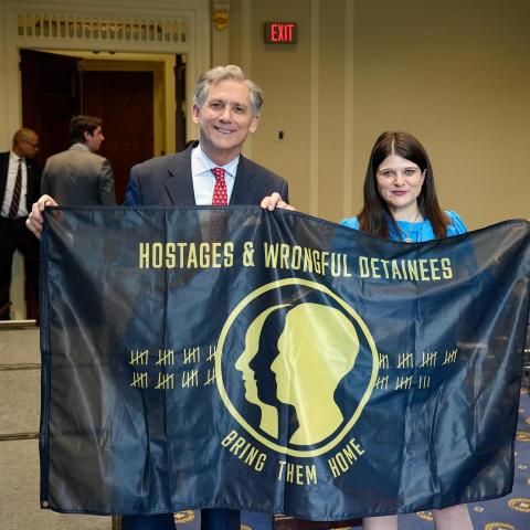 Rep. French Hill and Rep. Haley Stevens Holding U.S. Hostage and Wrongful Detainee Flag