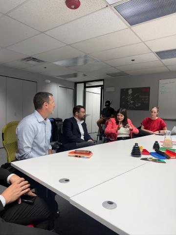 Rep. Stevens sits around a table with experts 