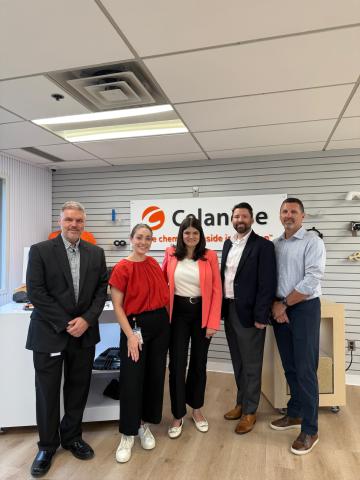 Rep. Stevens stands with experts in front of the Celanese sign 