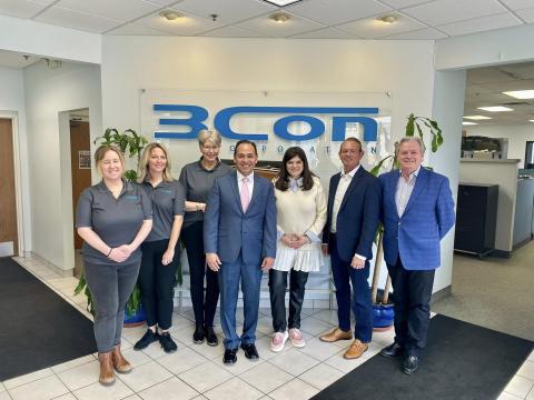 Rep. Stevens stands for a photo with experts at 3CON in Wixom 